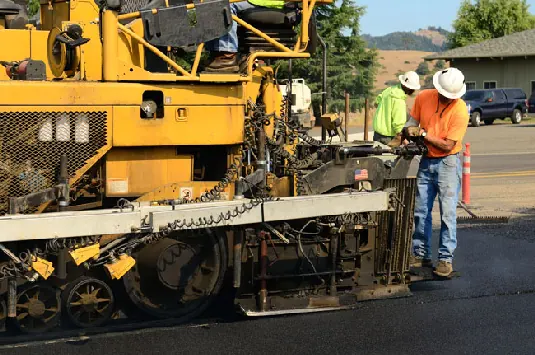 Driveway paving contractor working on a residential driveway in Arizona Driveway paving contractor working on a residential driveway paving project in Arizona
